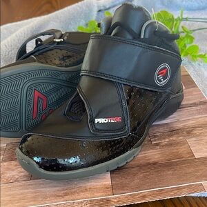 Black and Gray Athletic Shoes with Velcro Strap and Sturdy Sole